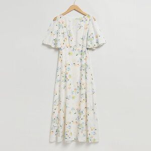 Short flutter sleeve maxi dress crafted from silk-like fabric. Worn once